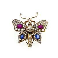 Gold butterfly brooch with diamond, ruby, and sapphire; approx. 1.20 ct.