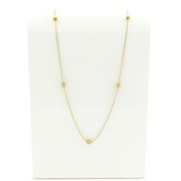 Golden twisted link chain with balls.