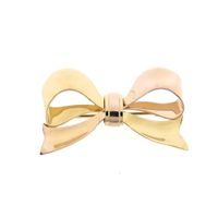 Vintage two-tone gold brooch as a bow