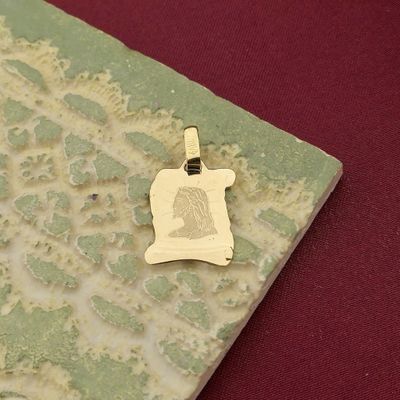 Image 1 of Gold pendant of the face of Jesus on parchment