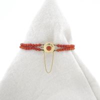 Antique red coral beaded bracelet with gold decorative clasp.
