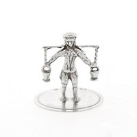 Antique silver statuette of a man with a yoke