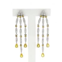 White gold stud earrings with yellow sapphire and diamond; 0.56 ct.