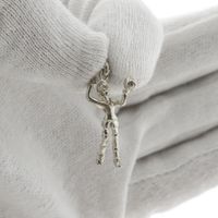 Silver pendant of a volleyball player