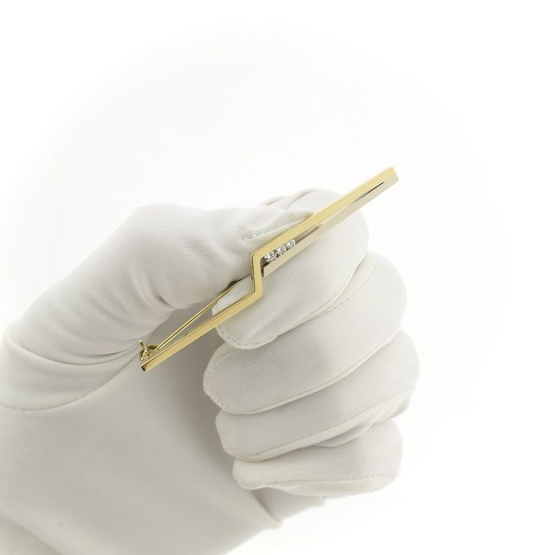 Image 12 of Two-tone gold long narrow brooch with diamonds; 0.15 ct.