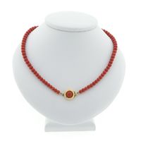Antique blood coral bead necklace with gold decorative clasp.