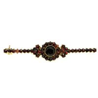 Vintage gold brooch with garnet stones