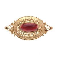 Vintage gold brooch with garnet stones