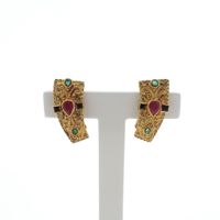 Golden oriental stud earrings with ruby, sapphire and emerald