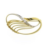Two-tone gold brooch with zirconia.