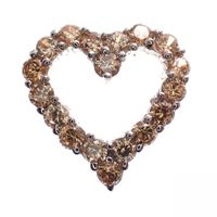 Silver pendant of a heart set with orange zirconia