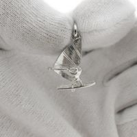 Silver pendant of a windsurfer